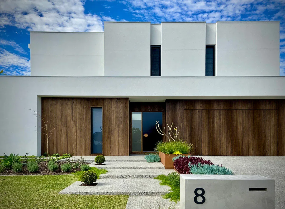 Modern Gold Coast home courtyard with timber deck and outdoor seating